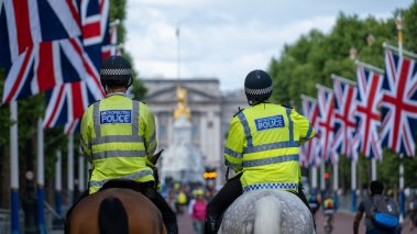  Two Mounted Police Officers Ride down The Mall in London 
