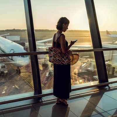 Woman on phone waiting to board plane